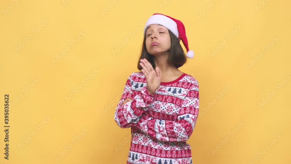 Young latin woman celebrating christmas day frowning face in displeasure, keeps arms folded Young latin woman celebrating christmas day frowning face in displeasure, keeps arms folded