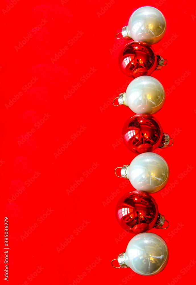 Christmas composition with white and red balls on red background, copy space. Flat lay, concept with festive ornaments. Christmas composition with white and red balls on red background, copy space. Flat lay, concept with festive ornaments.