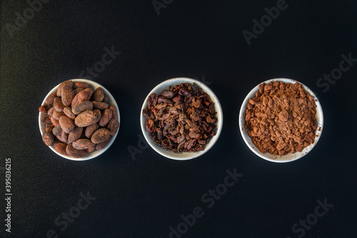 Cacao beans seeds, Cacao nibs and cacao powder isolated on black background.