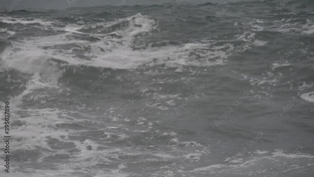 stormy sea pushed by heavy rain and wind forms big waves that break on the beach stormy sea pushed by heavy rain and wind forms big waves that break on the beach