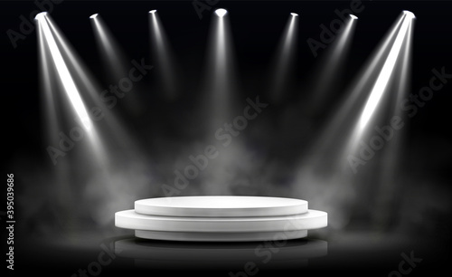 Round podium, empty stage illuminated by spotlights. Vector realistic mockup of circular platform, white pedestal, projector beams and smoke on black background. Round stand in showroom