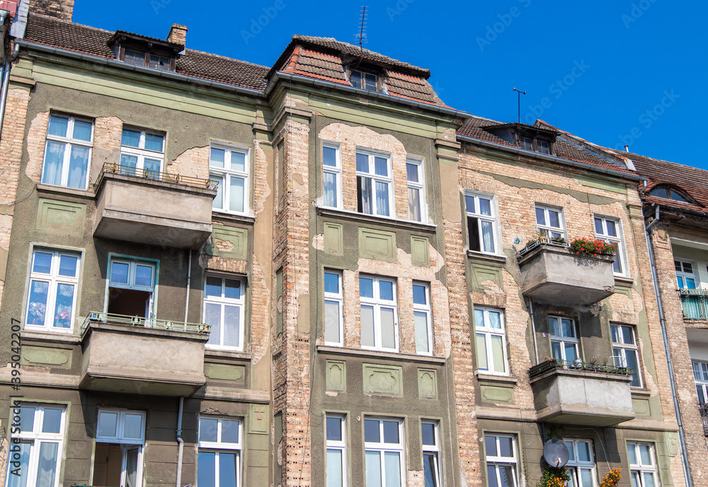 Old tenement houses on a background of blue sky
