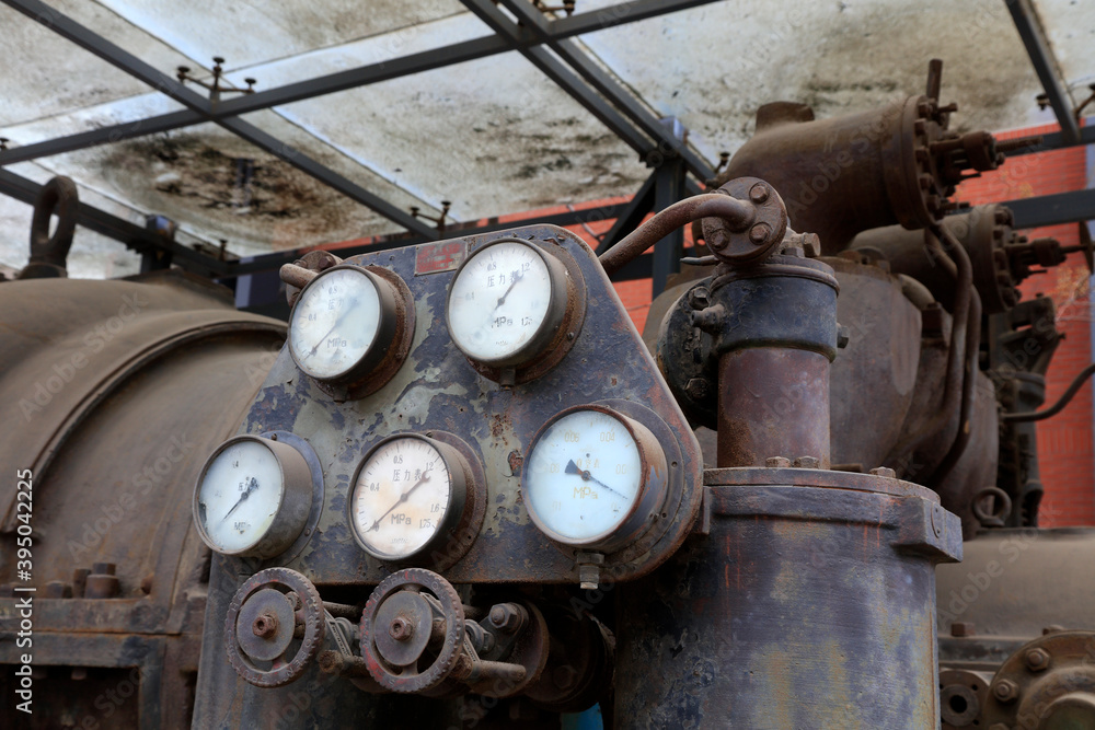 The rusty turbine generator lay idle in a corner of the factory The rusty turbine generator lay idle in a corner of the factory
