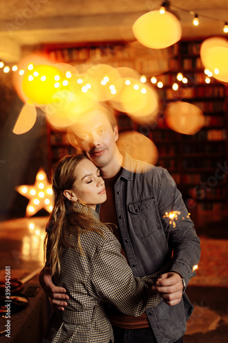 Lovely couple cuddling at home, charming husband hold sparklers, enjoy festive mood, cozy winter holidays, New Year and Christmas celebration concept