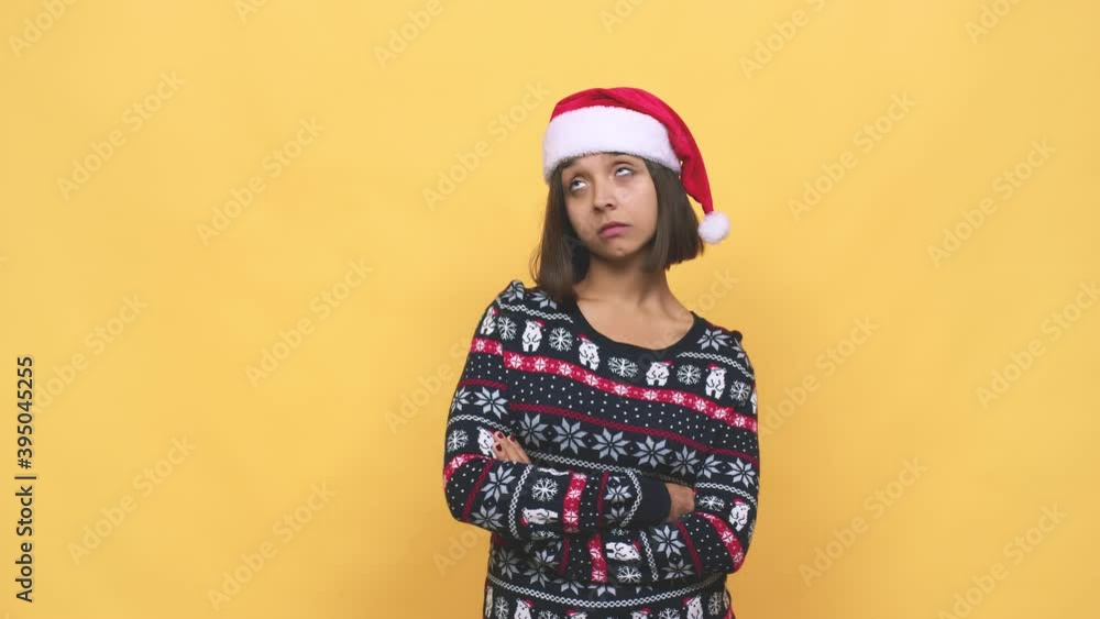 Young latin woman celebrating christmas day tired of a repetitive task Young latin woman celebrating christmas day tired of a repetitive task