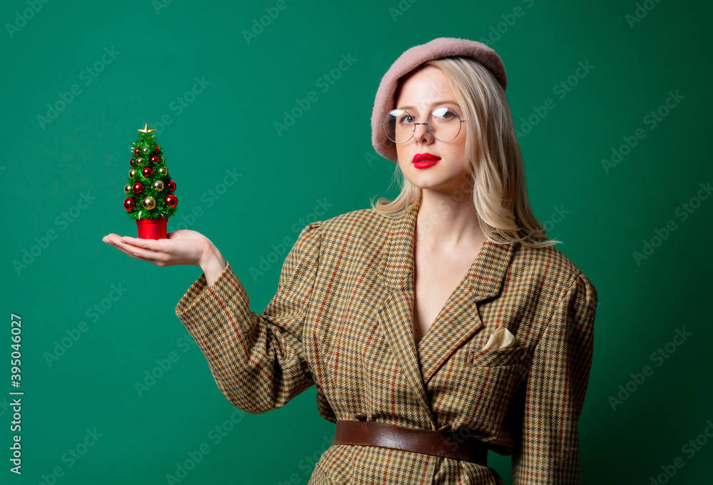 woman in style jacket and hat with Christmas tree woman in style jacket and hat with Christmas tree