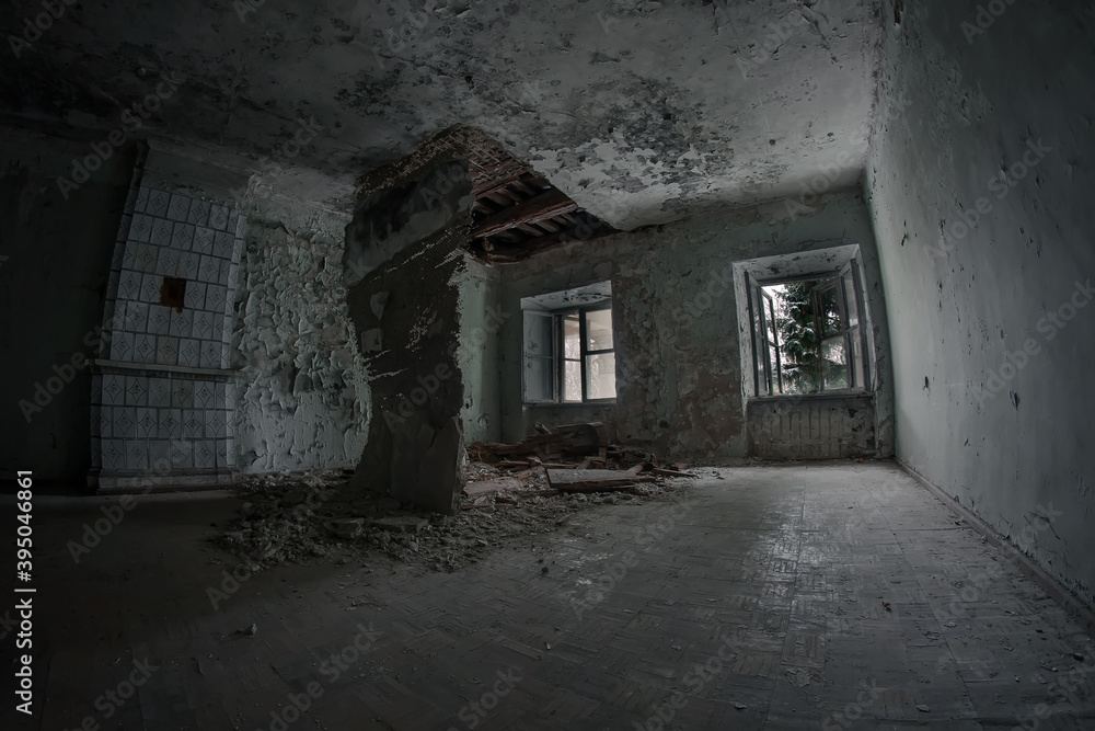 An old and scary room in an old abandoned house. The ceiling is collapsing, the trees outside the windows. Dirty and dark.