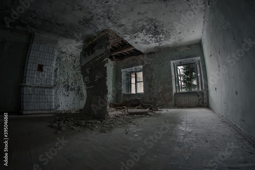 An old and scary room in an old abandoned house. The ceiling is collapsing, the trees outside the windows. Dirty and dark.