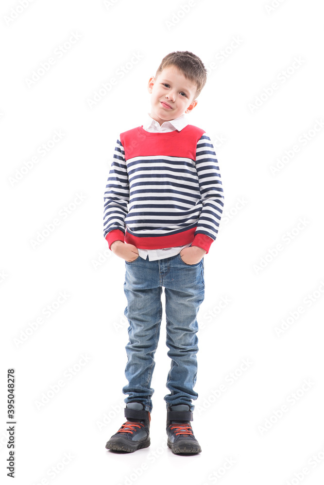 Smiling young cute boy child with hands in pockets looking at camera. Full body portrait isolated on white background. Smiling young cute boy child with hands in pockets looking at camera. Full body portrait isolated on white background.