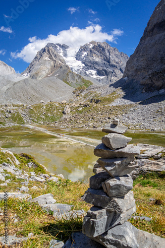 Cairn in front of the Cow lake, Lac des Vaches, in Vanoise national Park, France © daboost