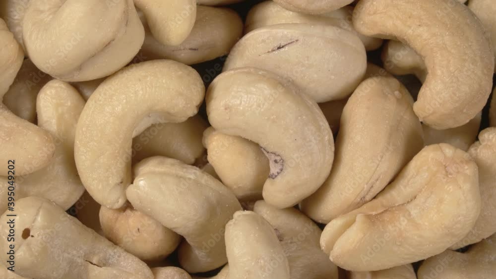 Rotation of cashew nut close-up. Salted nuts. Whole nut kernels. Rotation of cashew nut close-up. Salted nuts. Whole nut kernels.