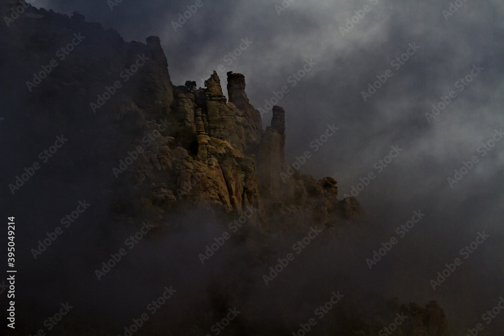 Dark clouds and fog surround spires on Mount Lemmon in Arizona