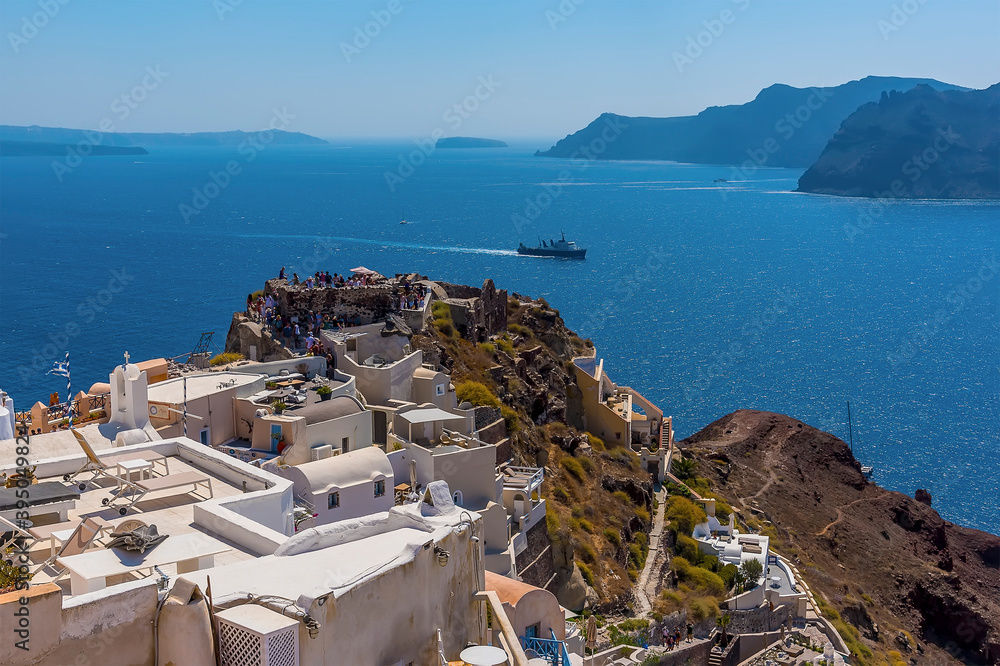 A view across the northern tip of Oia, Santorini towards the castle in summertime