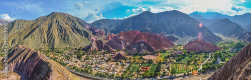 Panoramic stock photo of houses from the village of Purmamarca in Jujuy, Argentina. Landscape with colored mountains and hills