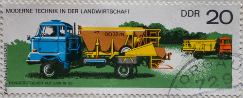 GERMANY, DDR - CIRCA 1977 : a postage stamp from Germany, GDR showing a fertilizer spreader DO 32 / N on the IFA W50 truck. Modern technology in agriculture photo