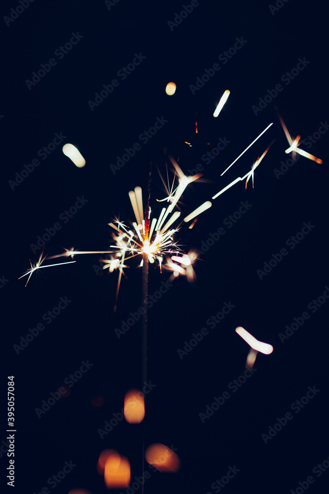 Obraz premium Sparkler overlay against black background. Festive, new years eve image. 