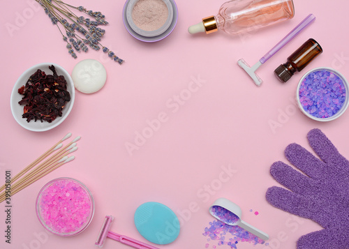 Spa, shower and personal hygiene products. Circular layout. Peels, lotions, oils, sea salt, cotton buds, facial brush on a pink background.