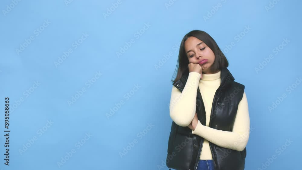 Young mixed race woman who feels sad and pensive, looking at copy space