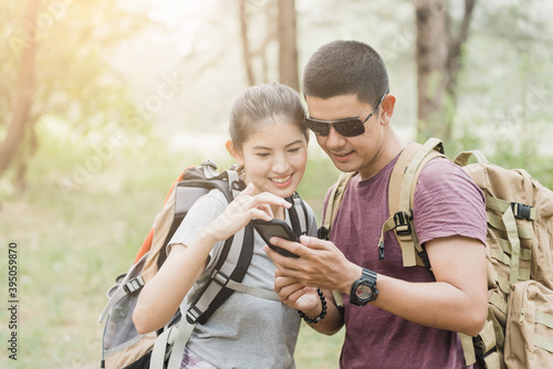 Tourists and asian couples are watching their smartphone screens. © iSomboon