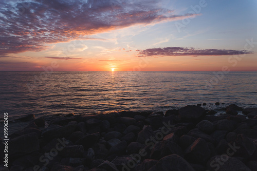 sunset on the beach with rocks and sea  © Nauris