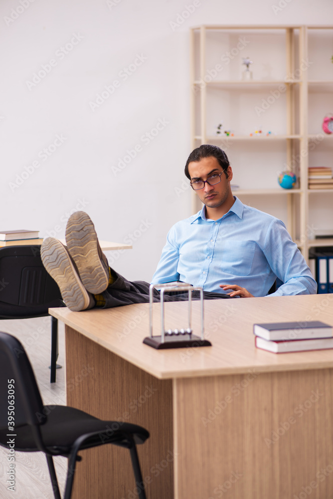 Young male teacher in the classroom