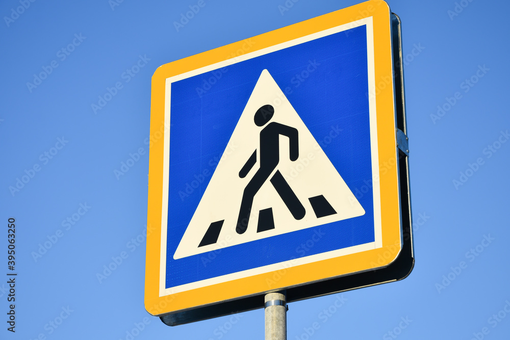 Road sign of a pedestrian crossing, close-up. Pedestrian safety. Road sign of a pedestrian crossing, close-up. Pedestrian safety.