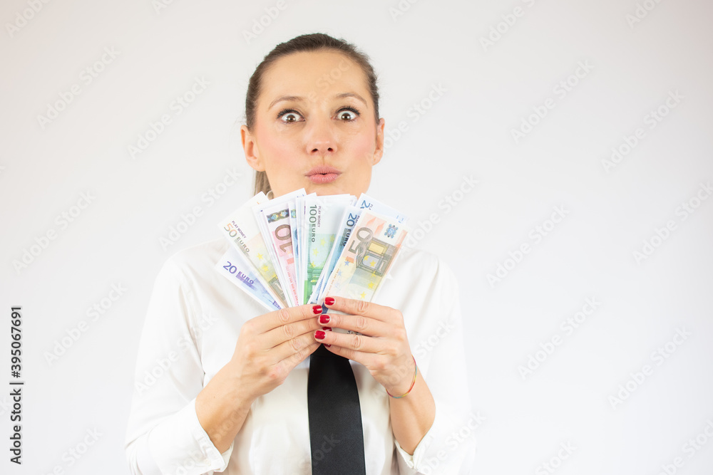 Photo of pretty cheerful business woman standing isolated over white background holding money. Photo of pretty cheerful business woman standing isolated over white background holding money.