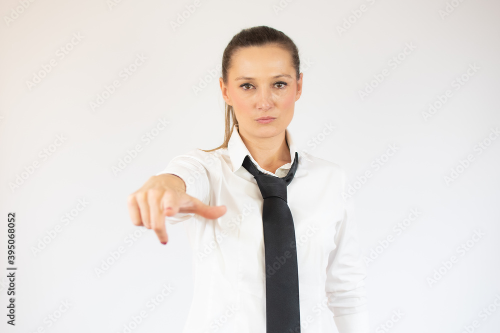 Business woman pointing to the camera serious over white background. Business woman pointing to the camera serious over white background.