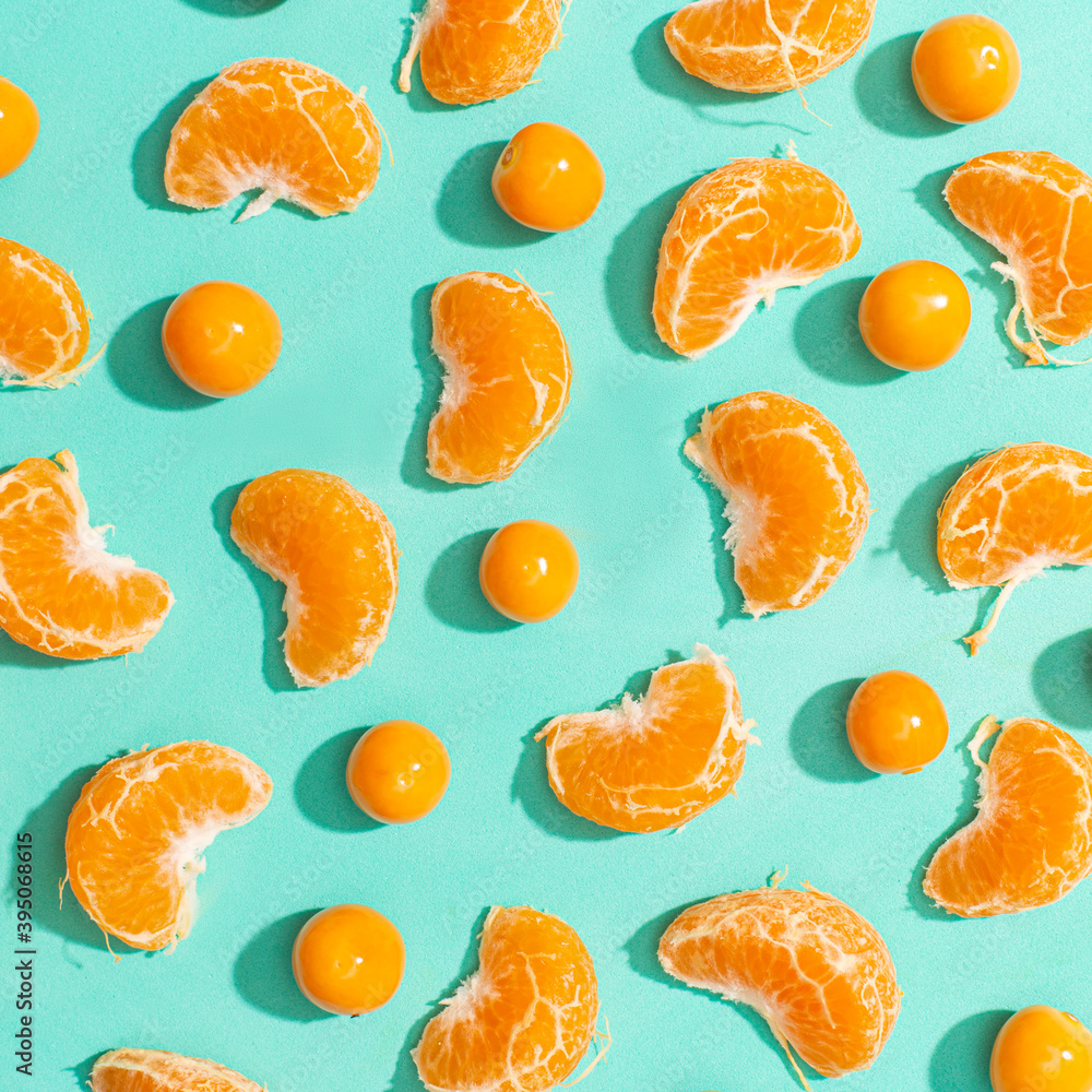 Tangerines and goldberries evenly spread over a cyan background Tangerines and goldberries evenly spread over a cyan background