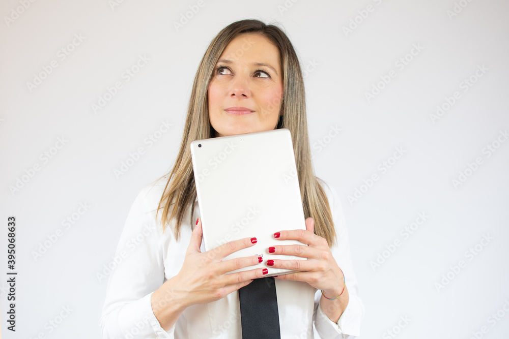 Business caucasian woman holding tablet thinking on a white background Business caucasian woman holding tablet thinking on a white background
