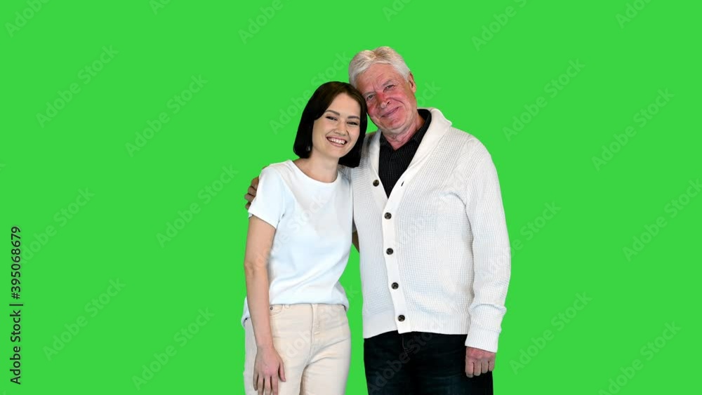 Happy girl with grandfather smiling to camera on a Green Screen, Chroma Key. Happy girl with grandfather smiling to camera on a Green Screen, Chroma Key.