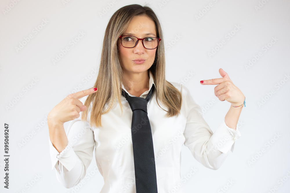 Surprised young beautiful businesswoman pointing fingers at herself over white background.