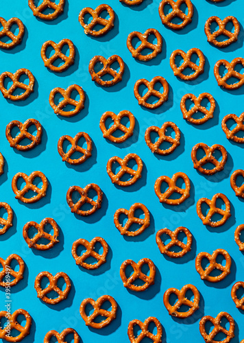 Pattern of salty pretzels over a light blue background
