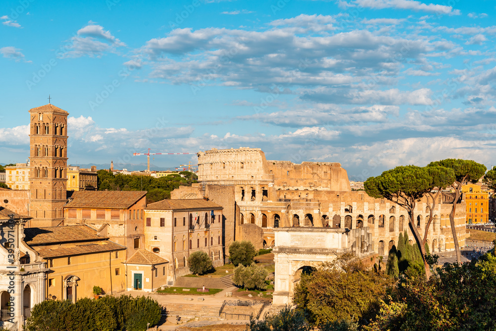 View of Forum of Rome and Colosseum a sunny summer day in Rome. It was for centuries the center of Roman public life.