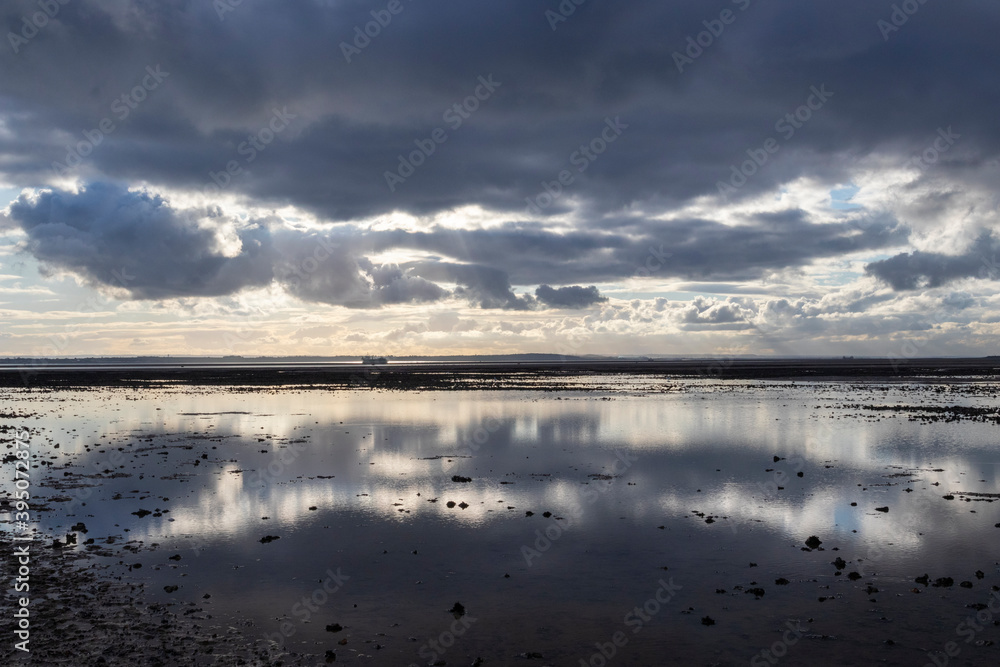 Reflections on Chalkwell beach, near Southend-on-Sea, Essex, England