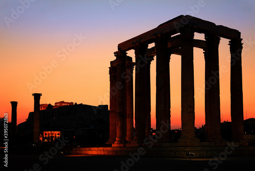 ATHENS, GREECE. The Temple of Olympian Zeus (considered one of the biggest of the ancient world) after sunset, with Acropolis in the background.