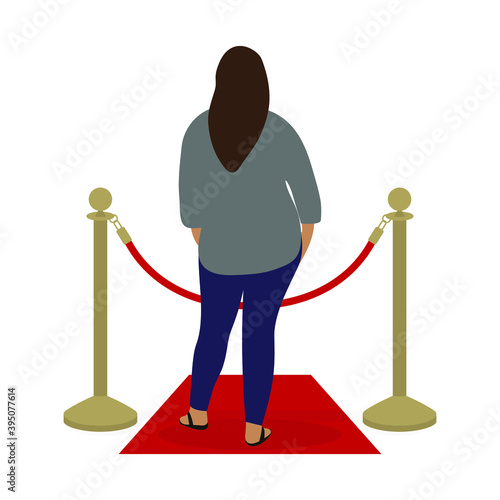 Fat female character stands on the red carpet in front of the fence posts