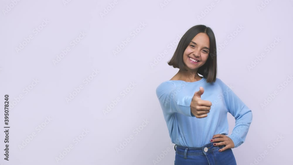 Young mixed race woman smiling and raising thumb up Young mixed race woman smiling and raising thumb up