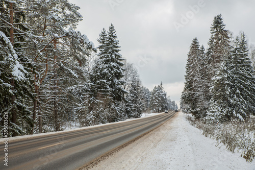 Winter landscape, road, winter track along the forest