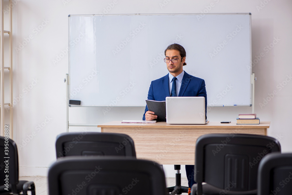 Young male business trainer in the office during pandemic Young male business trainer in the office during pandemic