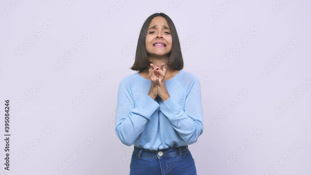 Young mixed race woman crossing fingers for having luck Young mixed race woman crossing fingers for having luck