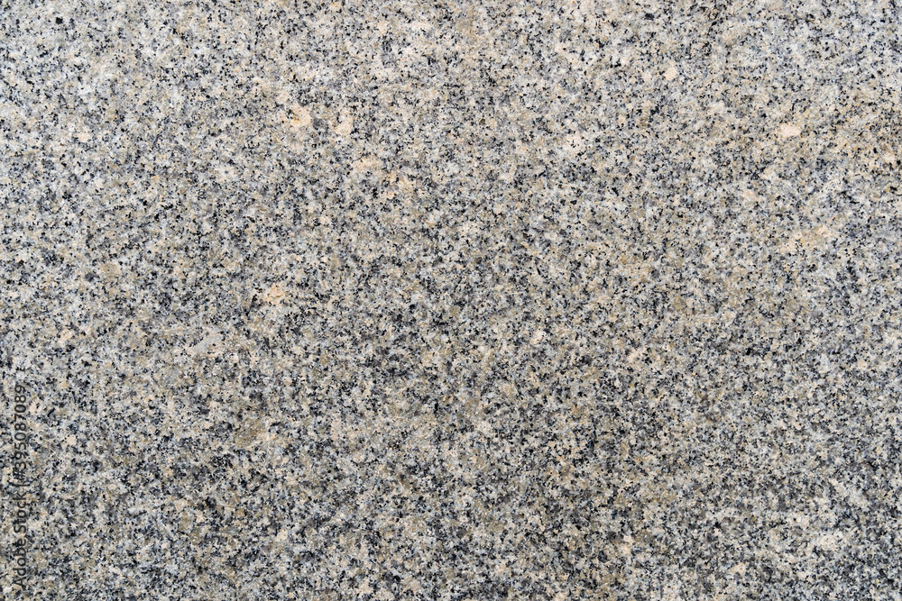 Fine granite texture pattern of grey stone material on a wall or floor Fine granite texture pattern of grey stone material on a wall or floor