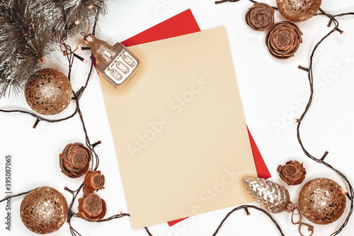 Beige sheet of paper on white background among Christmas decorations photo