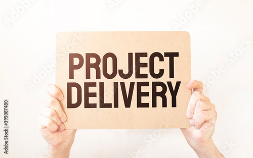Closeup Business man hand holding show blank paper sheet mock up empty white board space for shouting text rule or protest word. Text PROJECT DELIVERY