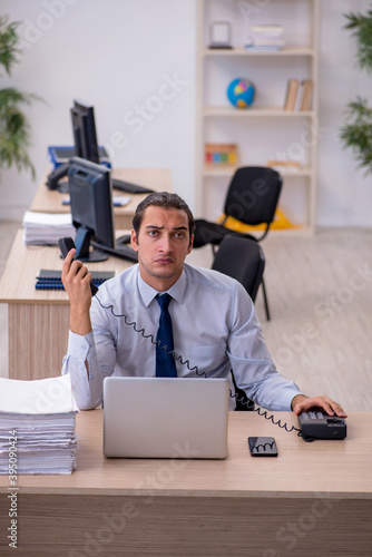 Young male employee sitting in the office