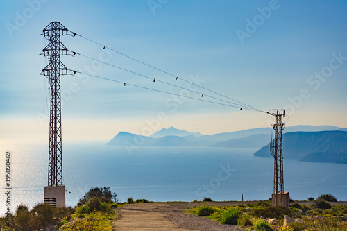 High voltage towers on coast.
