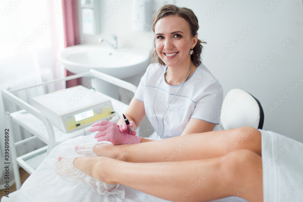 woman cosmetologist, legs electroepilation process professional hair removal procedure woman cosmetologist, legs electroepilation process professional hair removal procedure