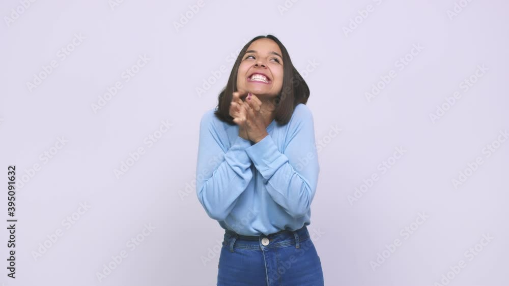 Young mixed race woman raising fist, feeling happy and successful victory concept Young mixed race woman raising fist, feeling happy and successful victory concept