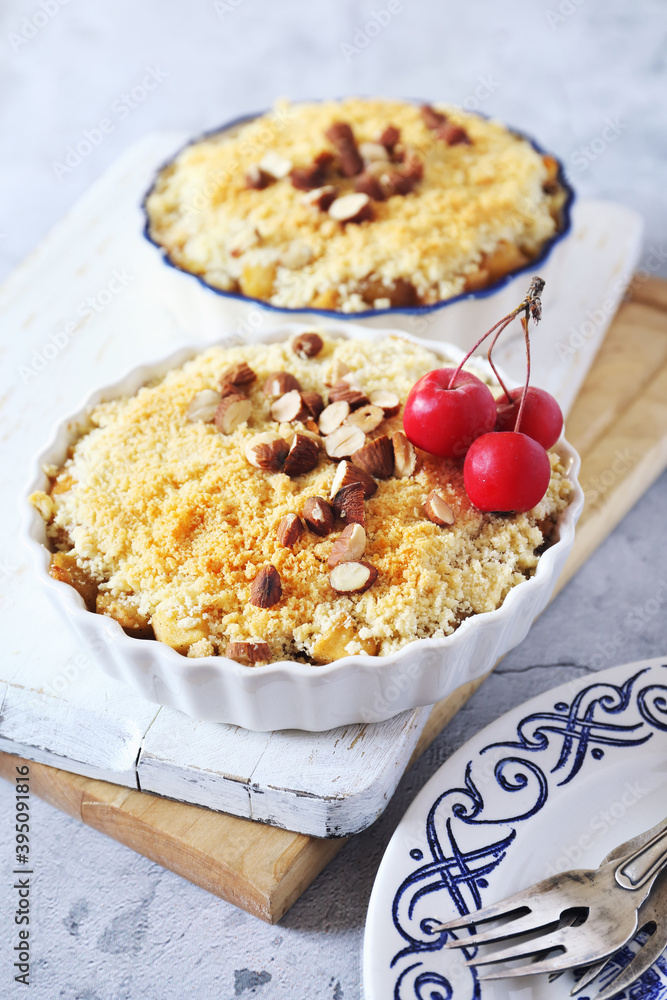 Apple crumble with almonds, two portions, red paradise apples dressing Apple crumble with almonds, two portions, red paradise apples dressing