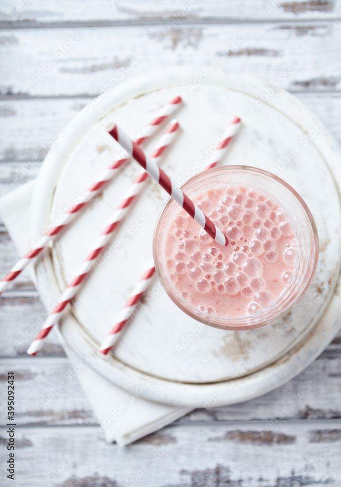 Strawberry Smoothie on bright wooden background. Top view. Strawberry Smoothie on bright wooden background. Top view.
